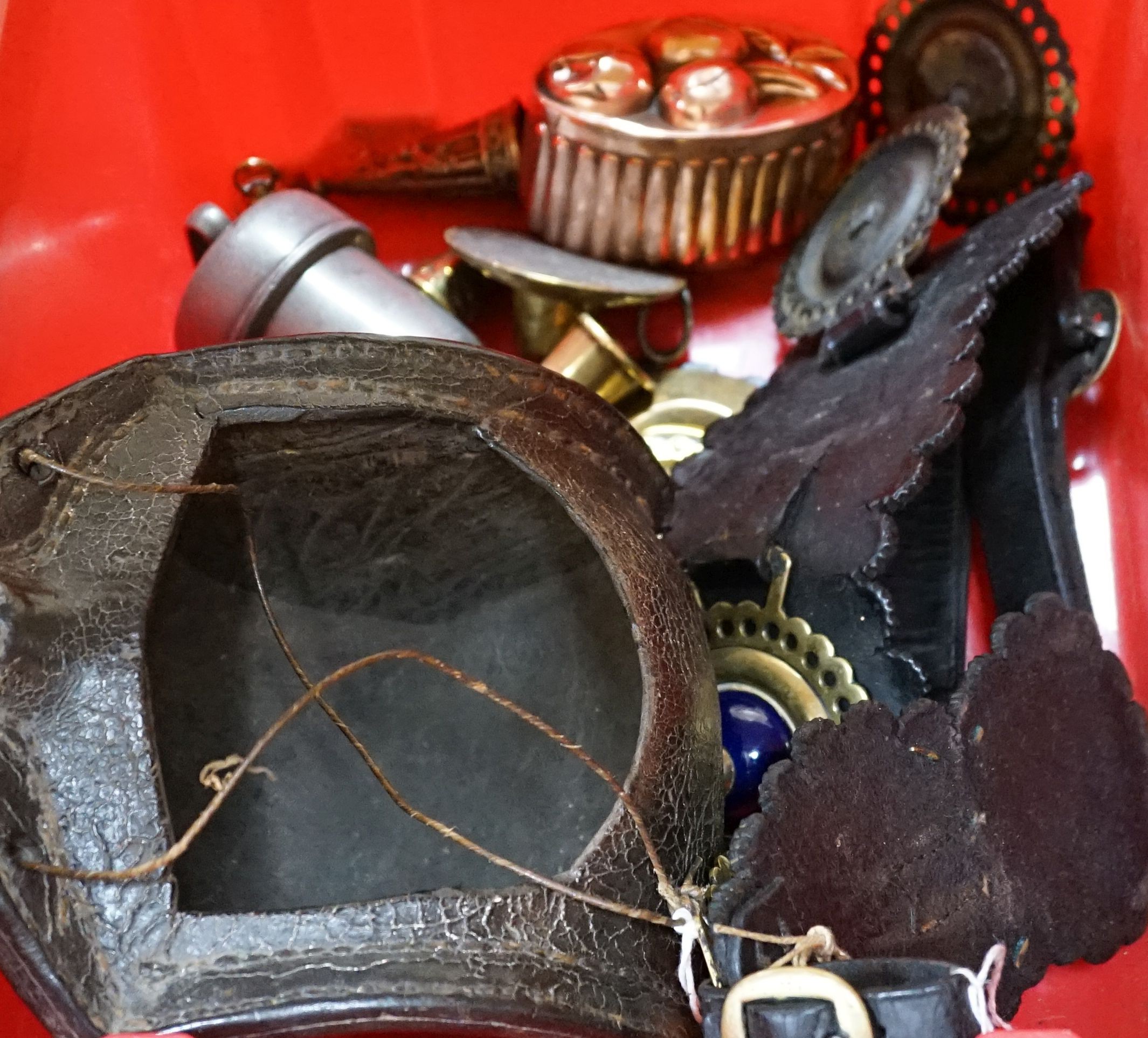 A leather cider costrel, miniature metalware including horn and two jelly moulds, brass horn, etc. and three martingales